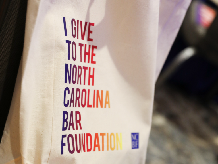 Canvas bag, rainbow lettering of "I give to the NCBF"